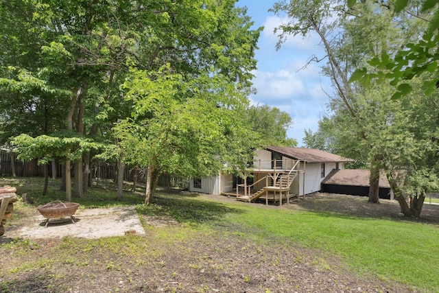 1808 80th St, Windsor Heights, IA 50324 - view of yard featuring an outdoor fire pit, stairs, and a wooden deck