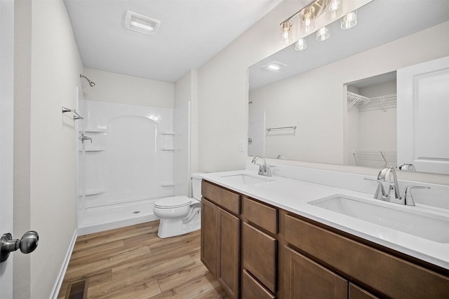 4400 Honey Bee Rdg, Des Moines, IA 50317 - full bathroom featuring wood finished floors, a shower, and double vanity