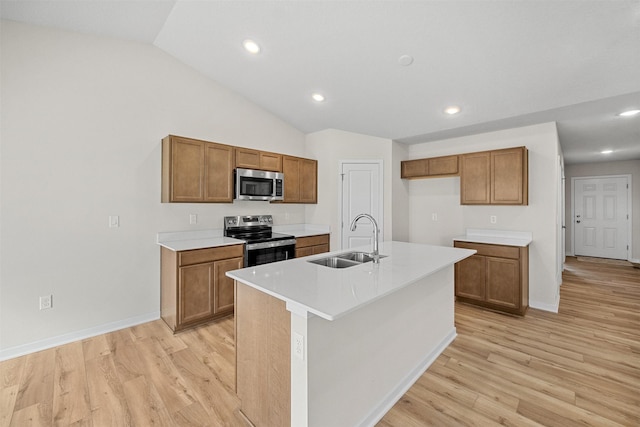 4400 Honey Bee Rdg, Des Moines, IA 50317 - kitchen featuring stainless steel appliances, brown cabinets, light wood-type flooring, vaulted ceiling, and light countertops
