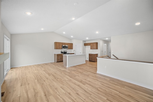 4400 Honey Bee Rdg, Des Moines, IA 50317 - unfurnished living room featuring light wood finished floors, vaulted ceiling, and recessed lighting