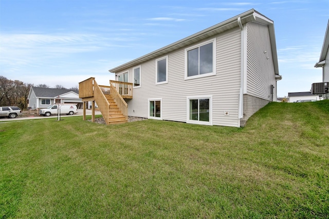 4400 Honey Bee Rdg, Des Moines, IA 50317 - rear view of house with stairs, a lawn, and a wooden deck