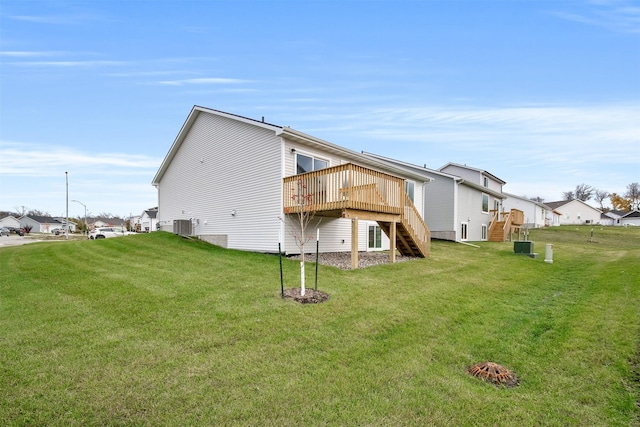 4400 Honey Bee Rdg, Des Moines, IA 50317 - back of house with stairway, a deck, and a lawn