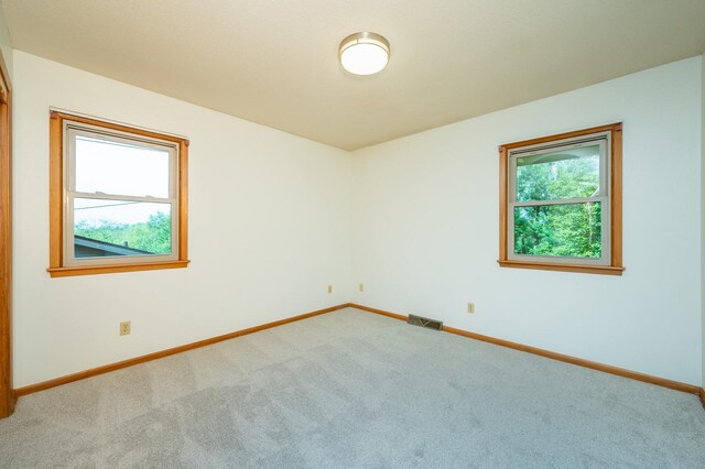 108 56th St, Des Moines, IA 50312 - carpeted empty room featuring baseboards