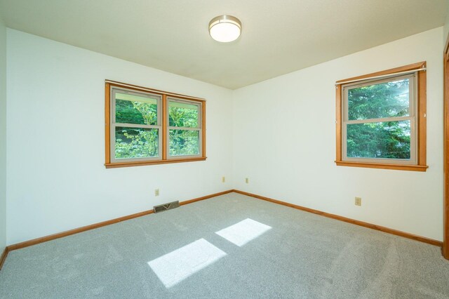 108 56th St, Des Moines, IA 50312 - carpeted spare room with plenty of natural light