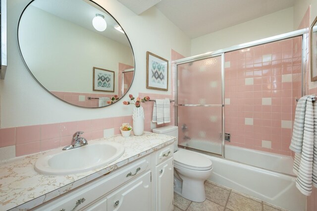 108 56th St, Des Moines, IA 50312 - bathroom featuring vanity, bath / shower combo with glass door, and tile patterned flooring