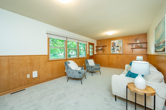 108 56th St, Des Moines, IA 50312 - living area featuring wood walls, wainscoting, and carpet