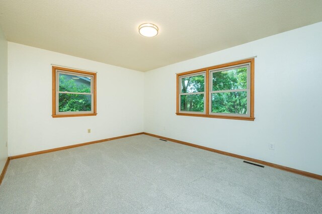 108 56th St, Des Moines, IA 50312 - carpeted empty room with baseboards