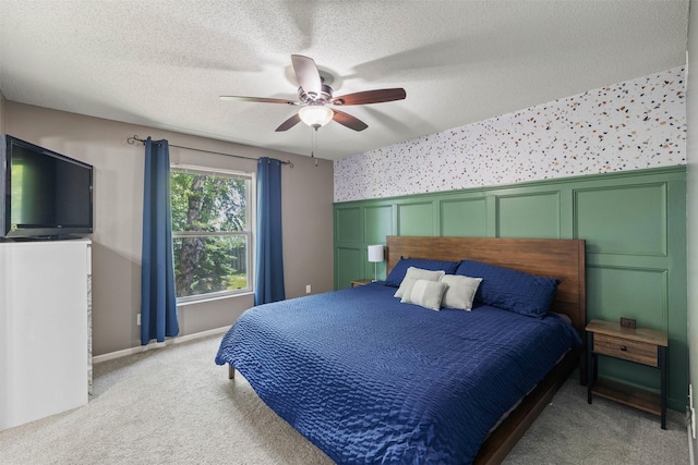 2128 NW 156th St Unit 31, Clive, IA 50325 - bedroom featuring wallpapered walls, carpet floors, a wainscoted wall, ceiling fan, and a textured ceiling