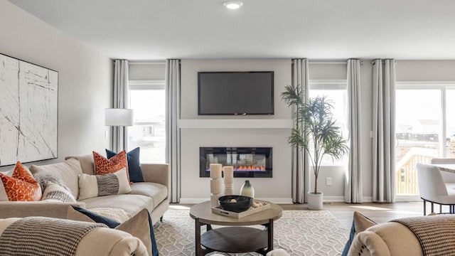 1030 34th St SE, Altoona, IA 50009 - living room featuring a glass covered fireplace, wood finished floors, and recessed lighting