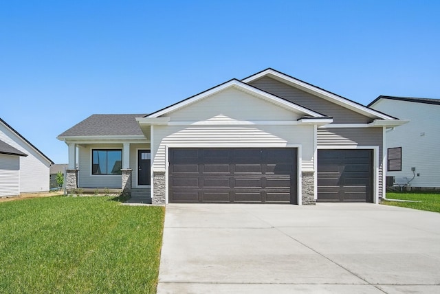 1819 Tuscany Dr SE, Altoona, IA 50009 - view of front of property with a garage, driveway, a front lawn, and stone siding