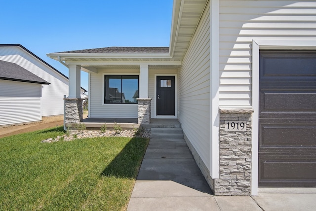 1819 Tuscany Dr SE, Altoona, IA 50009 - doorway to property with covered porch, stone siding, a shingled roof, a garage, and a yard