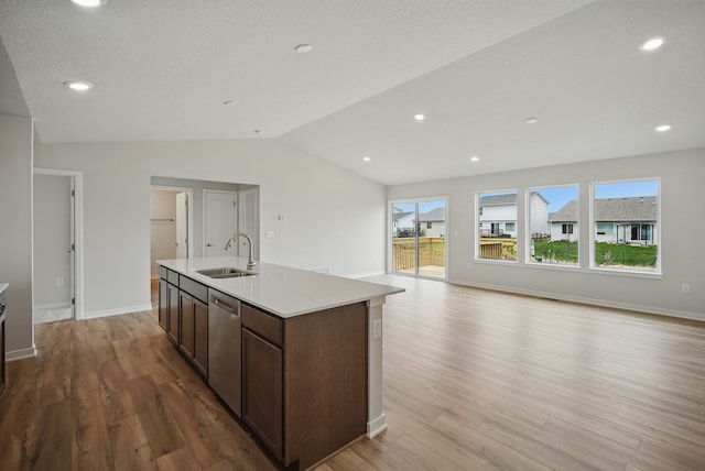 1819 Tuscany Dr SE, Altoona, IA 50009 - kitchen featuring stainless steel dishwasher, light wood finished floors, lofted ceiling, an island with sink, and open floor plan