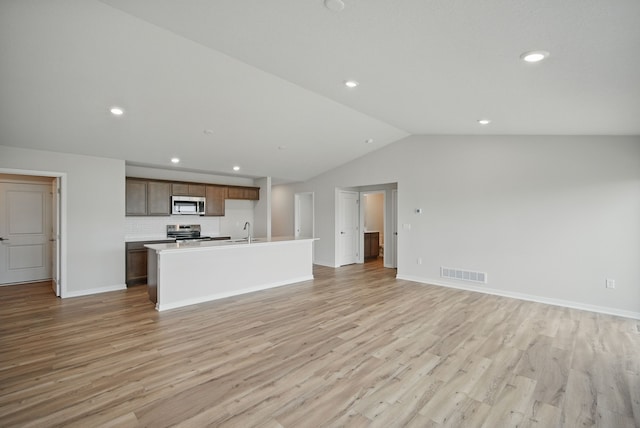 1819 Tuscany Dr SE, Altoona, IA 50009 - unfurnished living room featuring lofted ceiling, light wood-style flooring, and recessed lighting