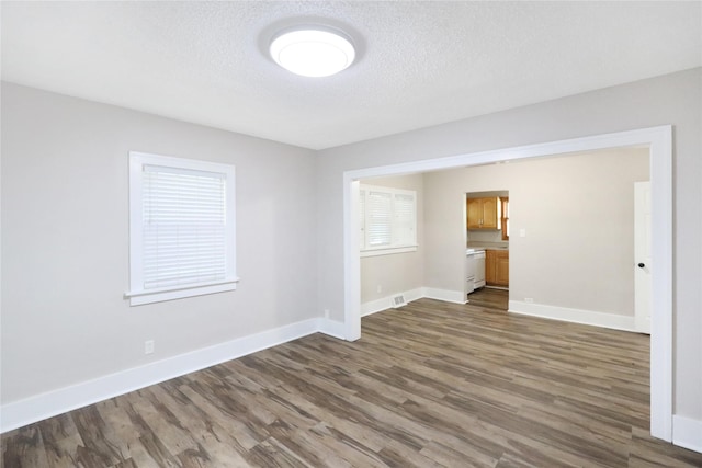 3904 3rd St, Des Moines, IA 50313 - empty room with dark wood finished floors and a textured ceiling