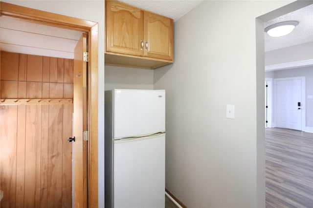 3904 3rd St, Des Moines, IA 50313 - kitchen featuring freestanding refrigerator, wood finished floors, and light brown cabinetry