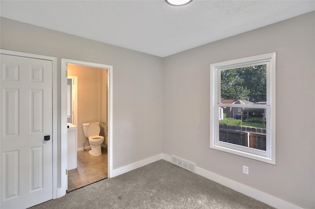 3904 3rd St, Des Moines, IA 50313 - unfurnished bedroom with carpet and ensuite bath