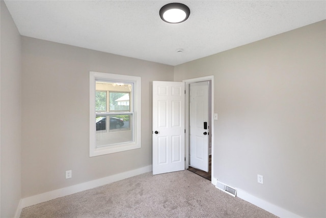 3904 3rd St, Des Moines, IA 50313 - spare room featuring carpet flooring and baseboards