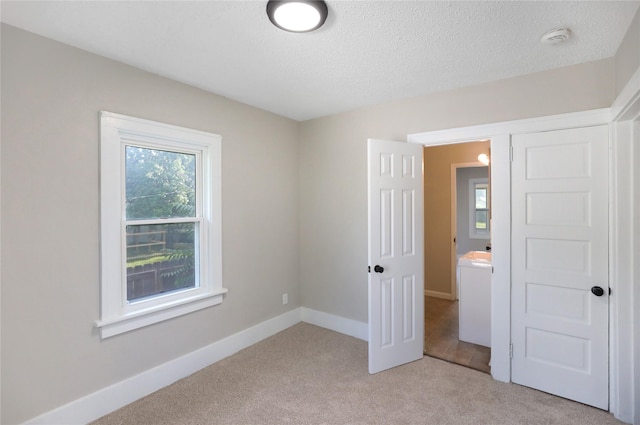 3904 3rd St, Des Moines, IA 50313 - unfurnished bedroom featuring light colored carpet and a textured ceiling