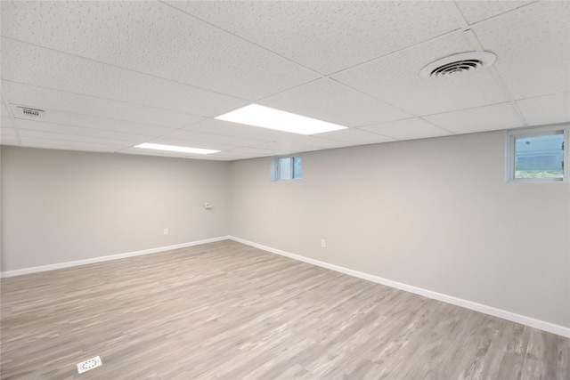 3904 3rd St, Des Moines, IA 50313 - below grade area with light wood finished floors and a drop ceiling