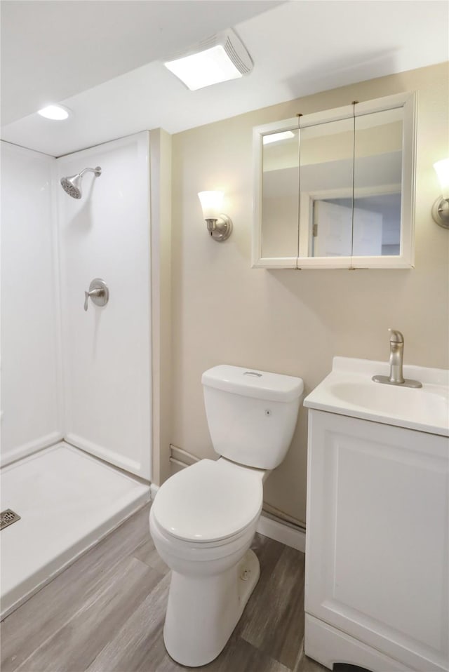 3904 3rd St, Des Moines, IA 50313 - bathroom featuring wood finished floors, vanity, and a shower