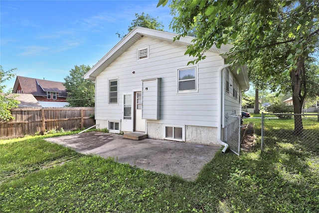 3904 3rd St, Des Moines, IA 50313 - rear view of house featuring a patio and a fenced backyard