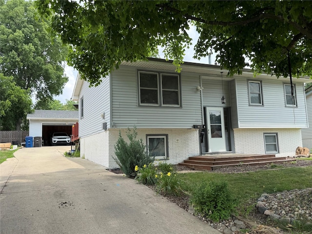 1105 Bundy St, Des Moines, IA 50315 - raised ranch with brick siding, concrete driveway, an outbuilding, and a front yard