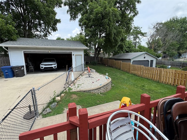 1105 Bundy St, Des Moines, IA 50315 - fenced yard featuring an outbuilding and a garage