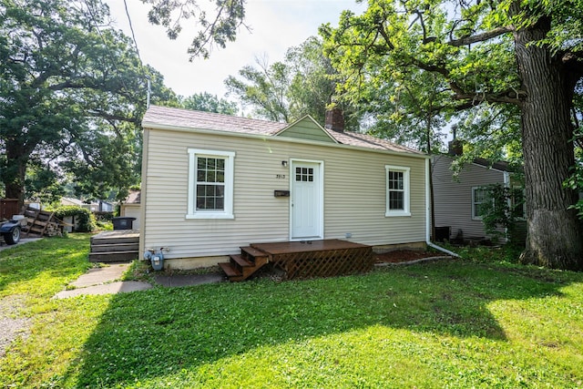 3913 Lawnwoods Dr, Des Moines, IA 50310 - back of property with a chimney, a yard, and a wooden deck