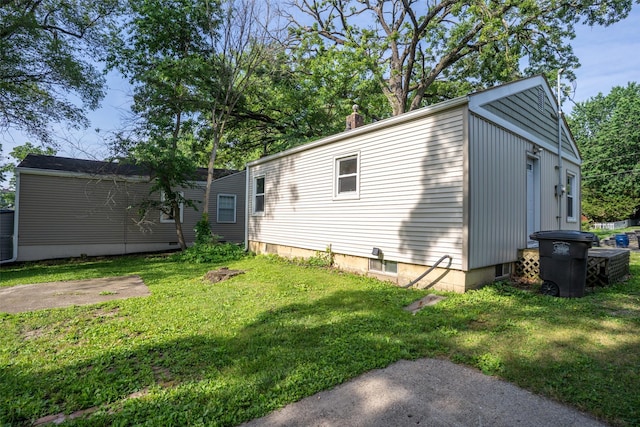 3913 Lawnwoods Dr, Des Moines, IA 50310 - view of side of property featuring a lawn and a chimney