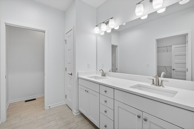 9322 Bellflower Ln, Norwalk, IA 50211 - bathroom featuring double vanity and a spacious closet