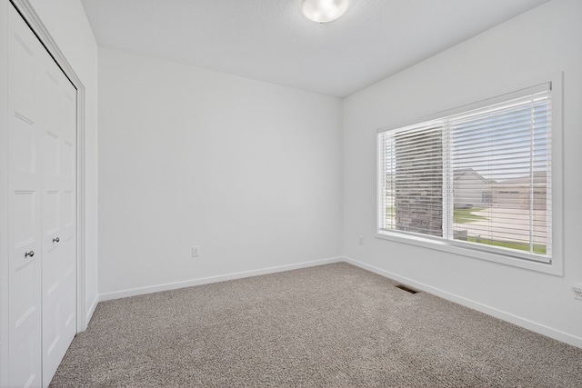 9322 Bellflower Ln, Norwalk, IA 50211 - unfurnished bedroom featuring carpet and a closet