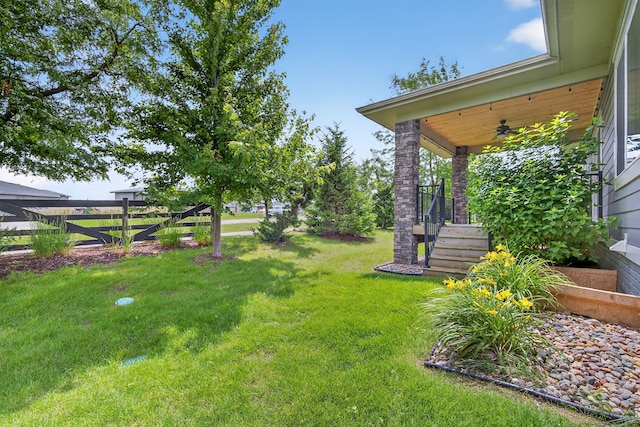 9322 Bellflower Ln, Norwalk, IA 50211 - view of green lawn with a ceiling fan