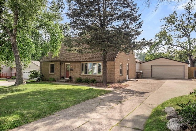 1034 66th St, Windsor Heights, IA 50324 - view of front of house featuring brick siding, a front yard, roof with shingles, driveway, and an outdoor structure