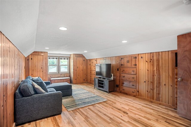 1034 66th St, Windsor Heights, IA 50324 - living room featuring hardwood / wood-style flooring, vaulted ceiling, wood walls, and recessed lighting