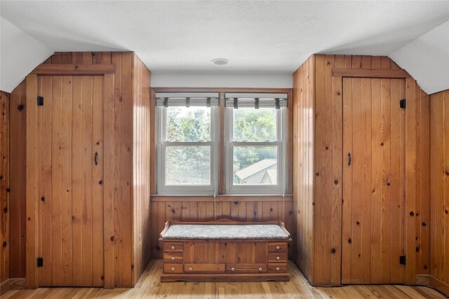 1034 66th St, Windsor Heights, IA 50324 - mudroom featuring wooden walls, light wood-type flooring, and vaulted ceiling