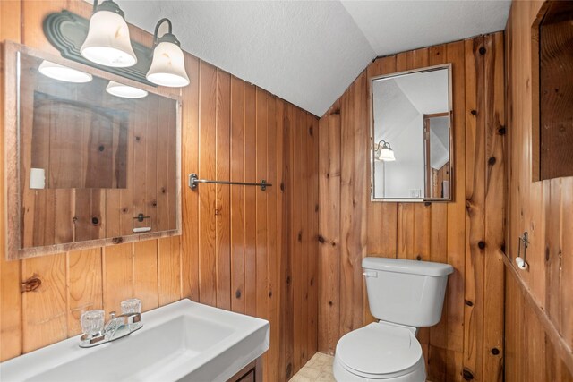 1034 66th St, Windsor Heights, IA 50324 - half bathroom with vaulted ceiling, wooden walls, and vanity