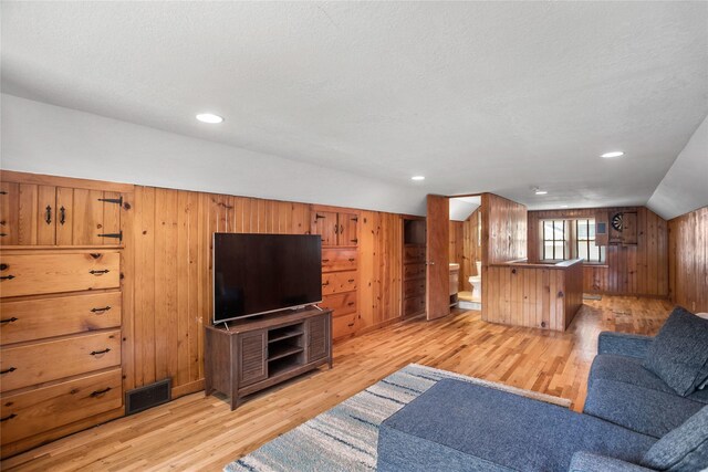 1034 66th St, Windsor Heights, IA 50324 - living room with light wood-style flooring, wooden walls, lofted ceiling, and recessed lighting