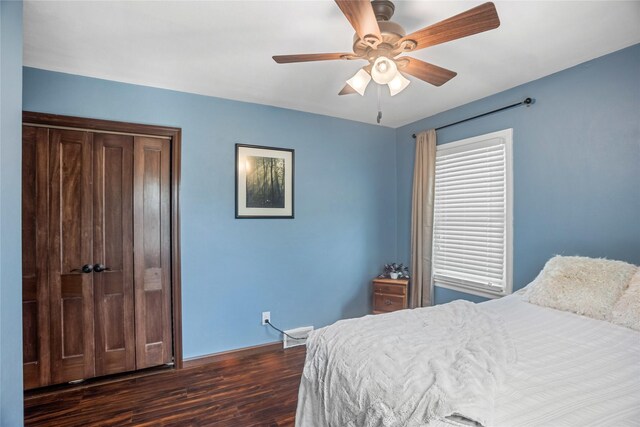 1034 66th St, Windsor Heights, IA 50324 - bedroom featuring dark wood-style floors, ceiling fan, and a closet
