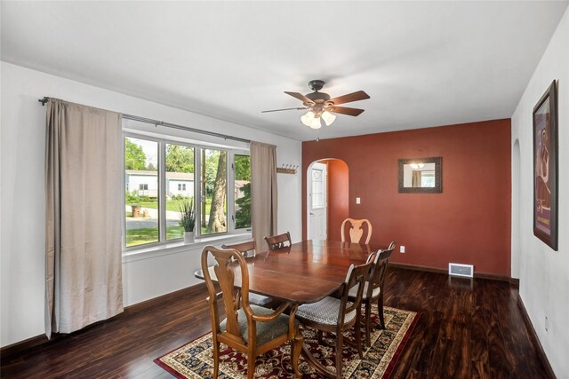 1034 66th St, Windsor Heights, IA 50324 - dining room featuring arched walkways, wood finished floors, and a ceiling fan