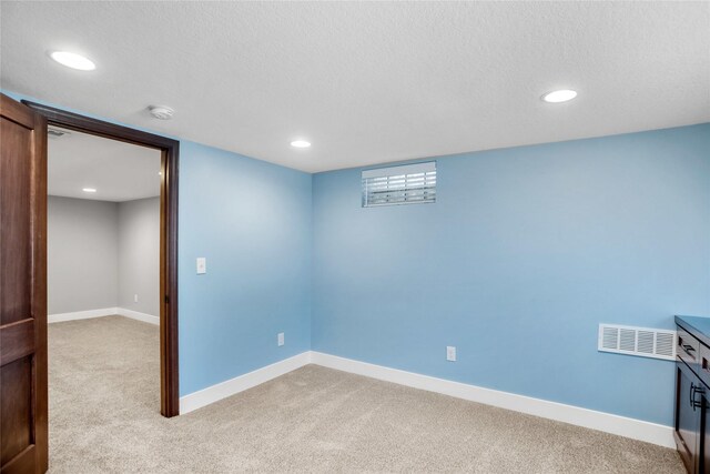 1034 66th St, Windsor Heights, IA 50324 - unfurnished room with light carpet, a textured ceiling, recessed lighting, and a smoke detector