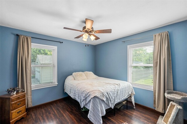1034 66th St, Windsor Heights, IA 50324 - bedroom with multiple windows, wood finished floors, and ceiling fan
