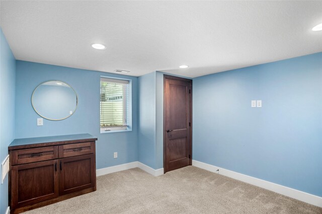 1034 66th St, Windsor Heights, IA 50324 - unfurnished bedroom featuring recessed lighting and light colored carpet