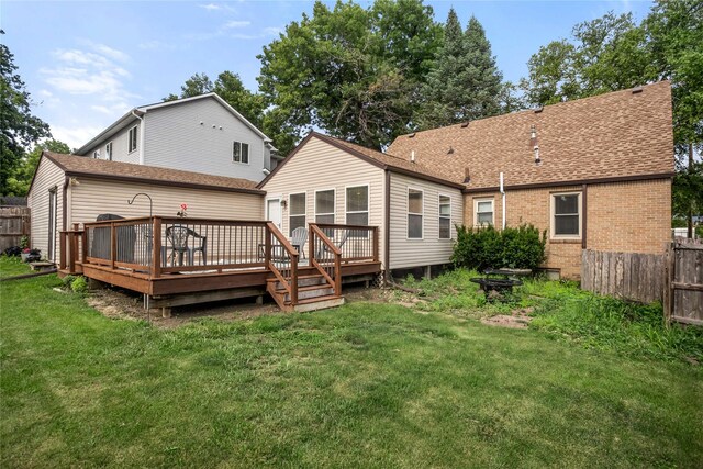 1034 66th St, Windsor Heights, IA 50324 - rear view of property featuring a deck, a shingled roof, and brick siding