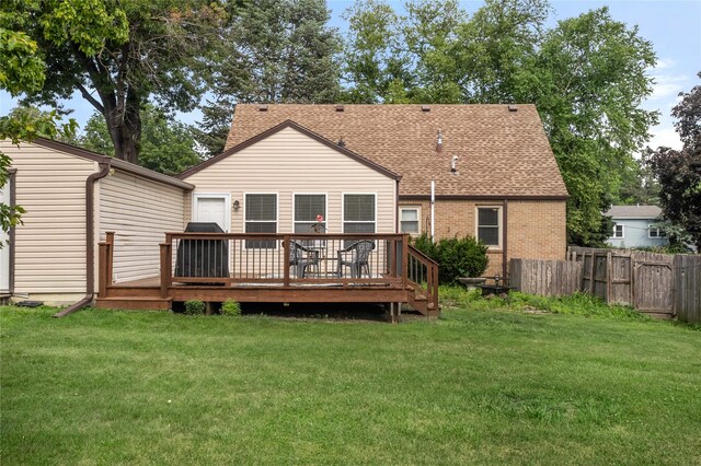 1034 66th St, Windsor Heights, IA 50324 - back of property with a wooden deck and a shingled roof