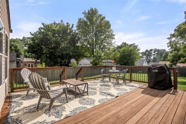 1034 66th St, Windsor Heights, IA 50324 - wooden terrace featuring area for grilling, outdoor dining area, and a fenced backyard