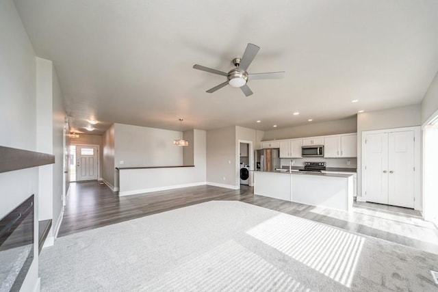 1636 S Redtail Ave, West Des Moines, IA 50265 - unfurnished living room featuring washer / clothes dryer, a ceiling fan, recessed lighting, and dark wood-style flooring