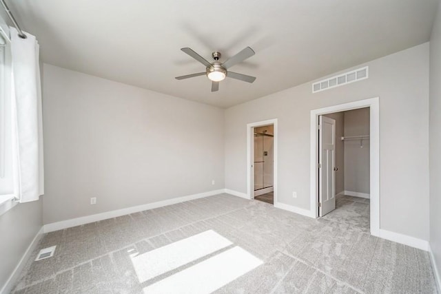 1636 S Redtail Ave, West Des Moines, IA 50265 - unfurnished bedroom featuring carpet floors, a walk in closet, ceiling fan, and a closet