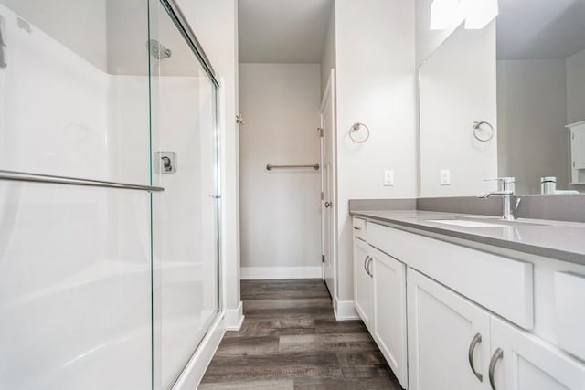 1636 S Redtail Ave, West Des Moines, IA 50265 - full bathroom with wood finished floors, a shower with shower door, and vanity