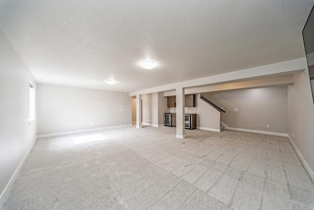 1636 S Redtail Ave, West Des Moines, IA 50265 - basement with a textured ceiling, light carpet, stairs, and beverage cooler