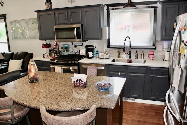 111 S 3rd Ave, Huxley, IA 50124 - kitchen featuring stainless steel appliances, a kitchen breakfast bar, backsplash, and healthy amount of natural light